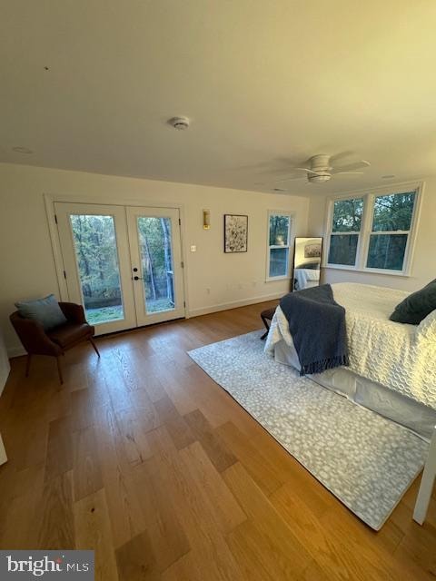 bedroom with french doors, access to exterior, wood-type flooring, and ceiling fan