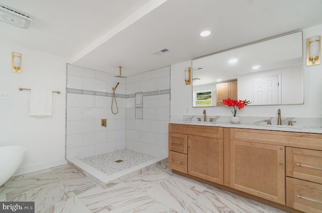 bathroom with vanity and a tile shower