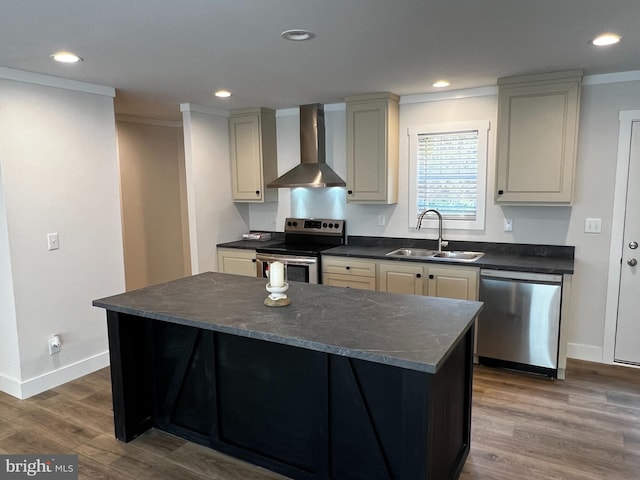 kitchen featuring hardwood / wood-style floors, appliances with stainless steel finishes, sink, wall chimney exhaust hood, and ornamental molding