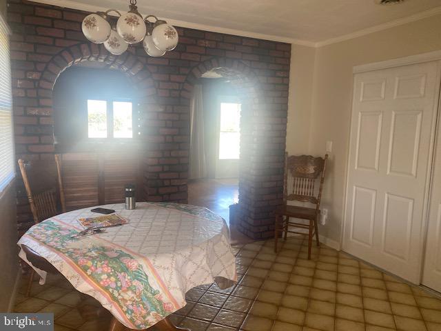 tiled dining room with crown molding