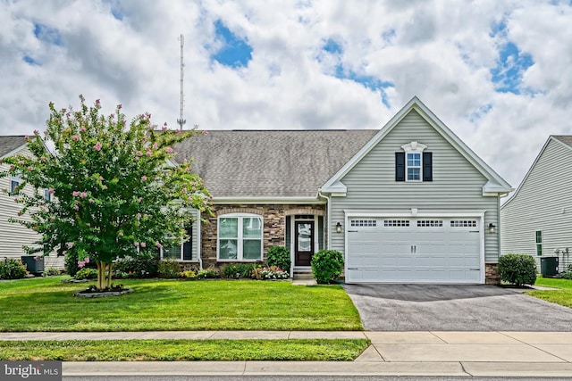 view of front of property with a garage, central AC unit, and a front lawn