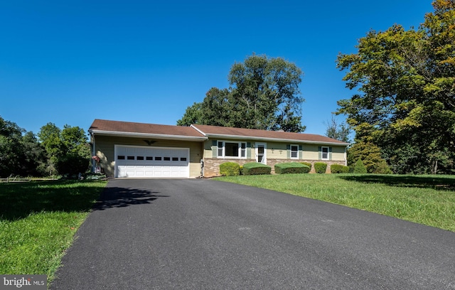 ranch-style house featuring a garage and a front yard