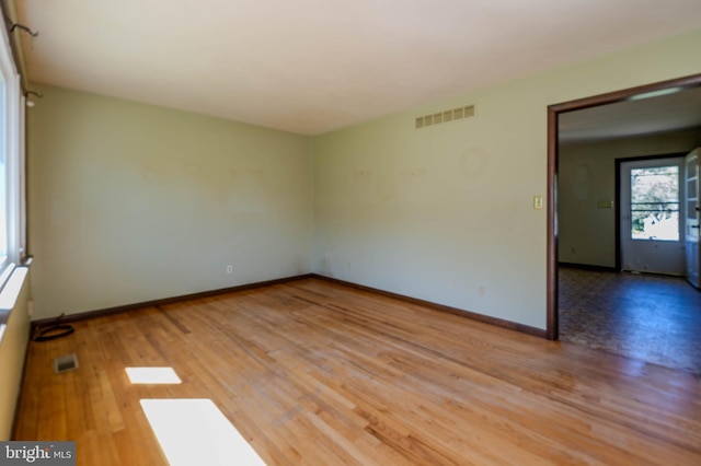 unfurnished room featuring hardwood / wood-style flooring