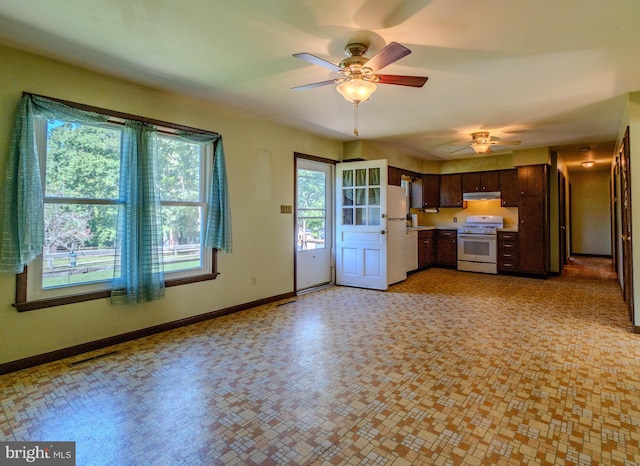 interior space featuring white appliances, dark brown cabinets, and ceiling fan