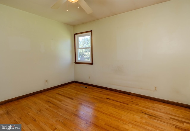 empty room featuring ceiling fan and light hardwood / wood-style floors