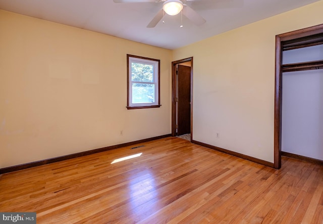 unfurnished bedroom with light hardwood / wood-style flooring, ceiling fan, and a closet