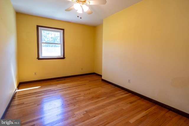 spare room featuring light hardwood / wood-style flooring and ceiling fan