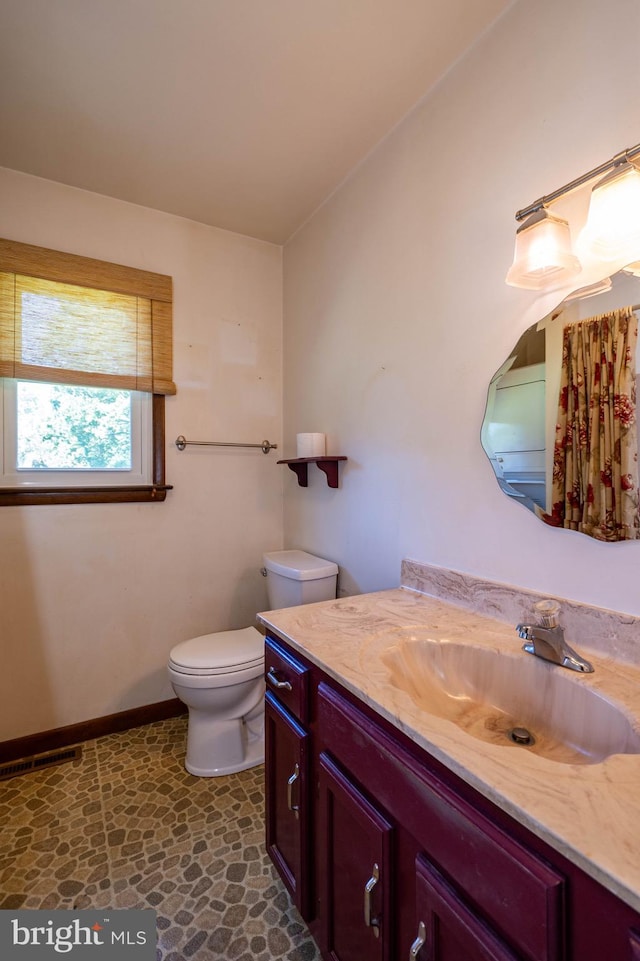 bathroom with vanity and toilet