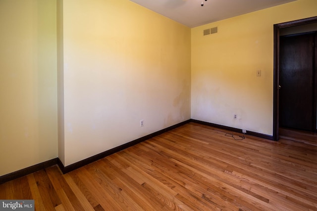 empty room with hardwood / wood-style flooring