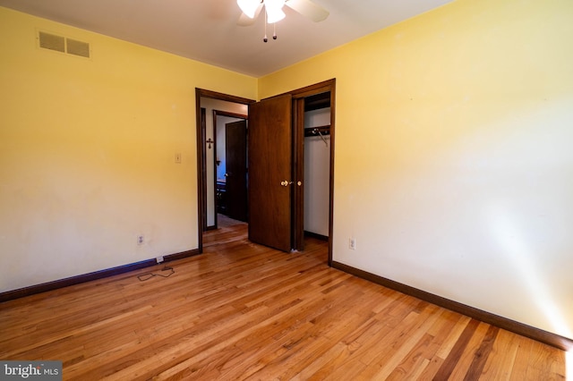 spare room with ceiling fan and light wood-type flooring