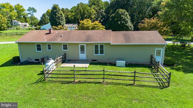 back of house featuring a lawn and central AC