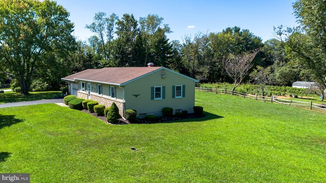 view of side of property featuring a yard