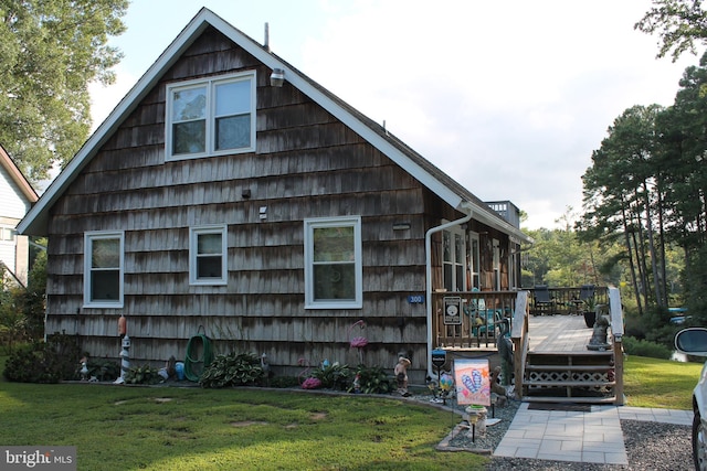 view of home's exterior featuring a yard and a deck