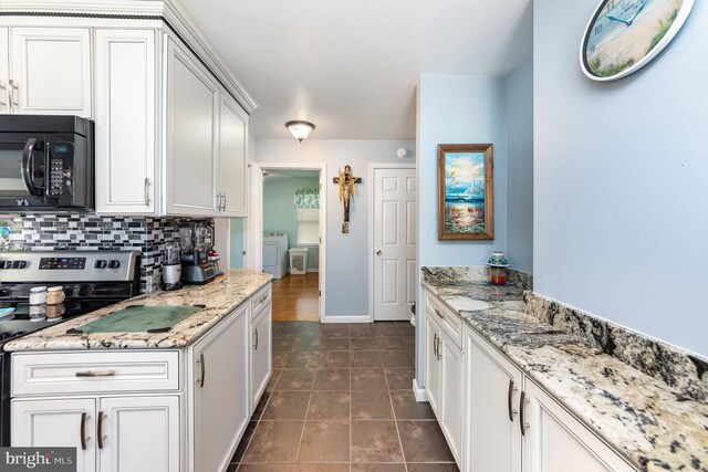 kitchen featuring white cabinets, dark tile patterned flooring, range with electric stovetop, and decorative backsplash