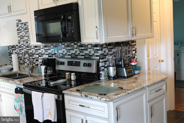 kitchen featuring tasteful backsplash, sink, white cabinets, light stone countertops, and stainless steel range with electric stovetop