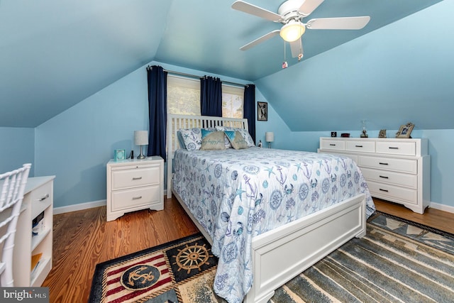 bedroom with ceiling fan, lofted ceiling, baseboards, and wood finished floors