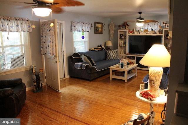 living room with ceiling fan and wood-type flooring