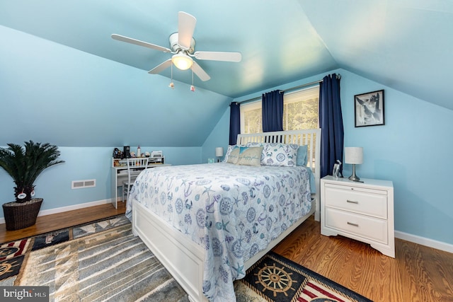 bedroom with vaulted ceiling, ceiling fan, baseboards, and wood finished floors