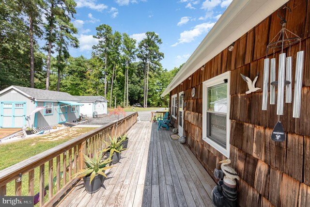 deck featuring a storage shed and an outbuilding