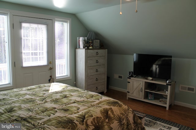 bedroom with vaulted ceiling and dark hardwood / wood-style floors