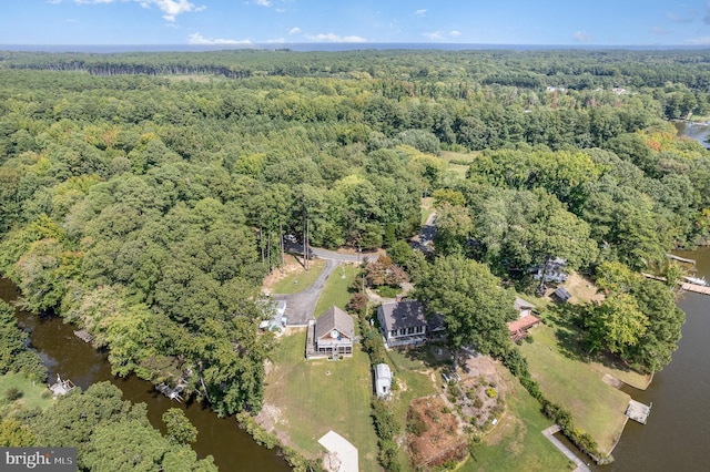 bird's eye view with a forest view and a water view