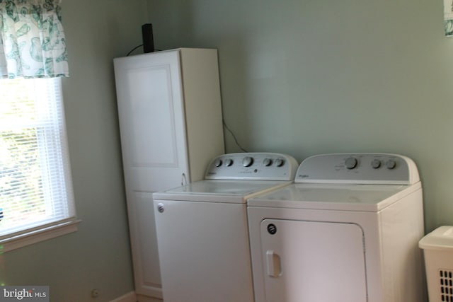 laundry area with washer and dryer and cabinets