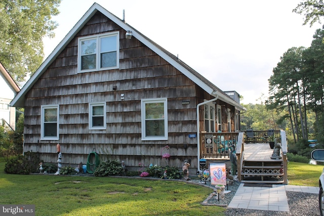 view of side of home with a lawn and a wooden deck