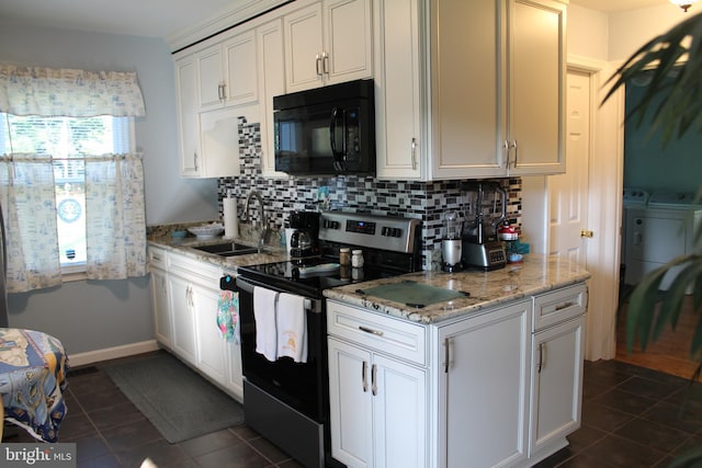 kitchen with decorative backsplash, a sink, separate washer and dryer, black microwave, and stainless steel electric range oven