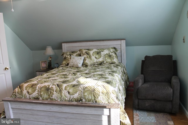 bedroom featuring wood-type flooring and vaulted ceiling