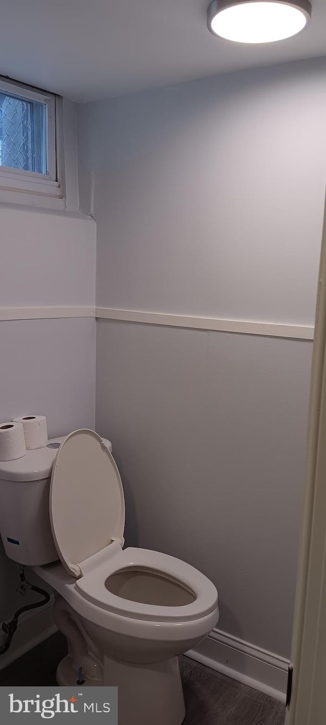 bathroom with hardwood / wood-style floors and toilet