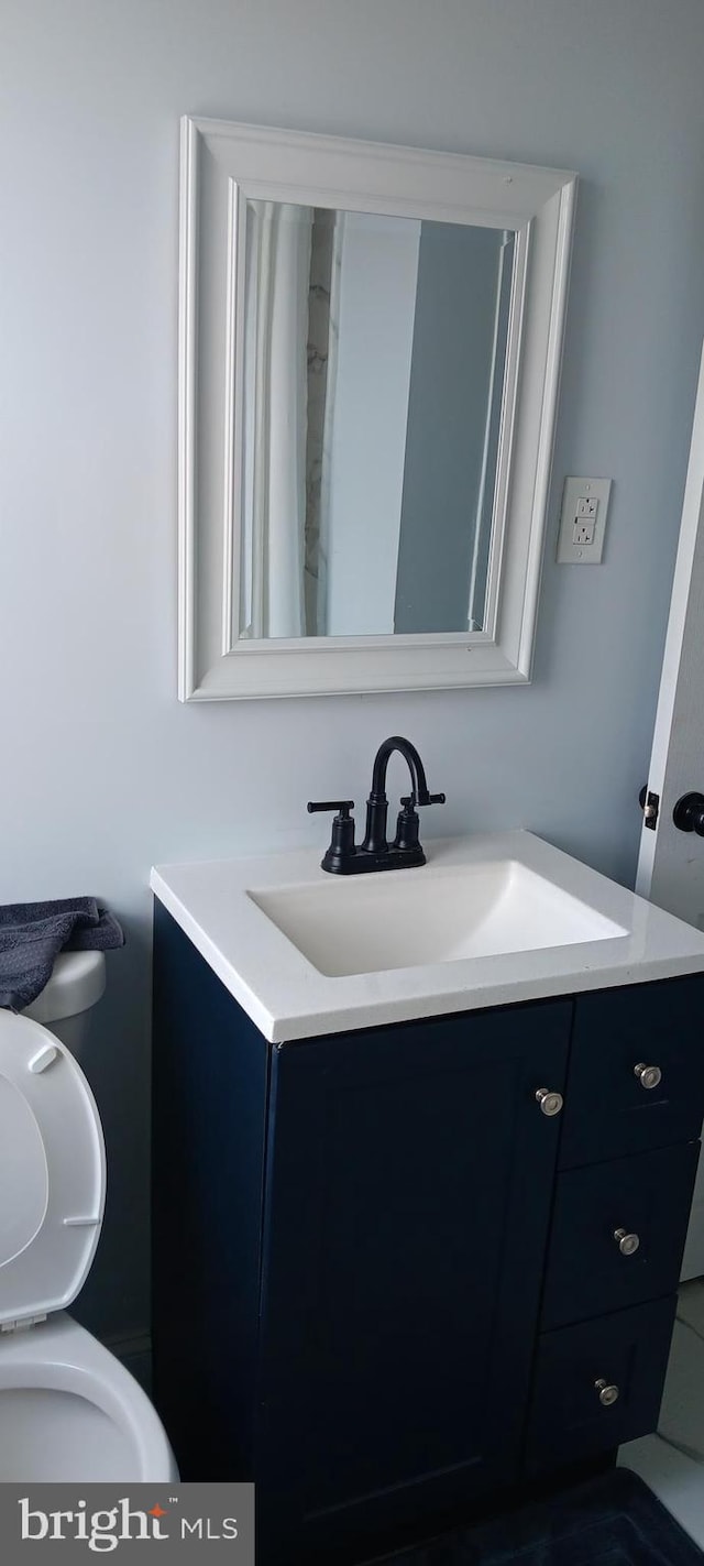 bathroom featuring toilet and vanity