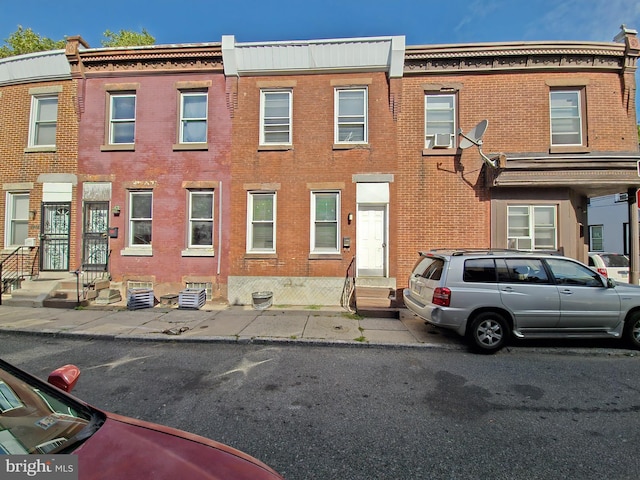 view of property featuring brick siding and entry steps