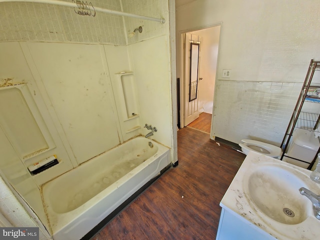 bathroom with vanity, bathing tub / shower combination, toilet, and wood finished floors