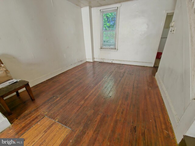 empty room featuring dark hardwood / wood-style flooring