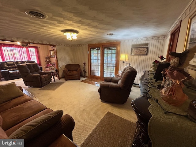 living room featuring visible vents, a textured ceiling, a healthy amount of sunlight, and carpet flooring