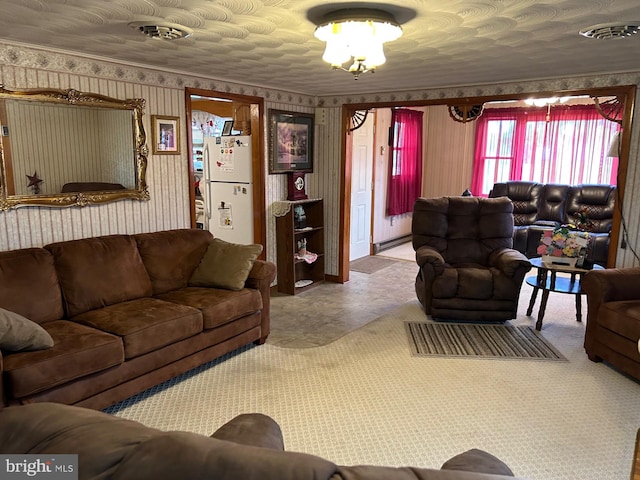 living room featuring visible vents, wallpapered walls, and a baseboard radiator