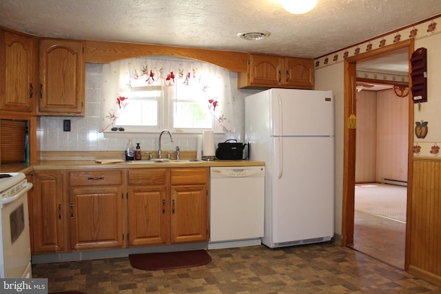 kitchen featuring white appliances, visible vents, a sink, light countertops, and dark floors