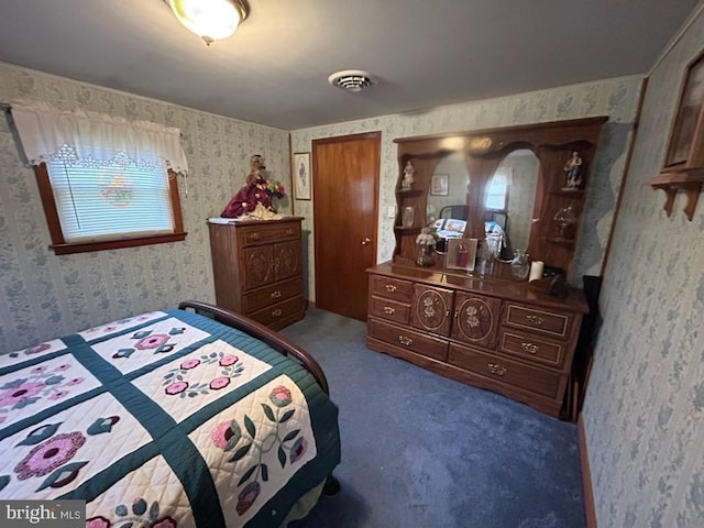 bedroom with wallpapered walls, visible vents, and carpet floors