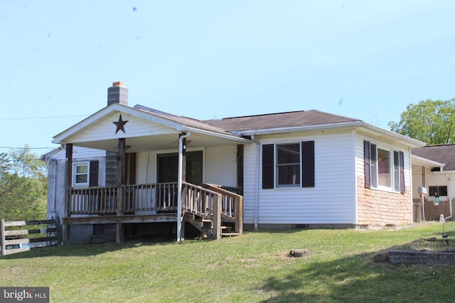 view of front of home with covered porch and a front yard