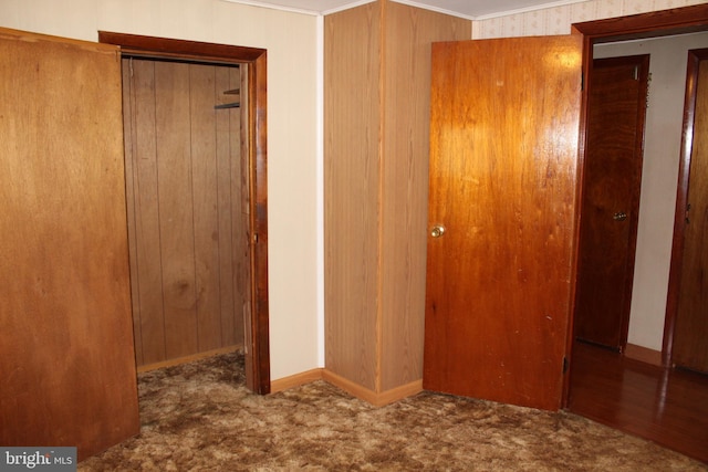 interior space featuring carpet, a closet, and baseboards