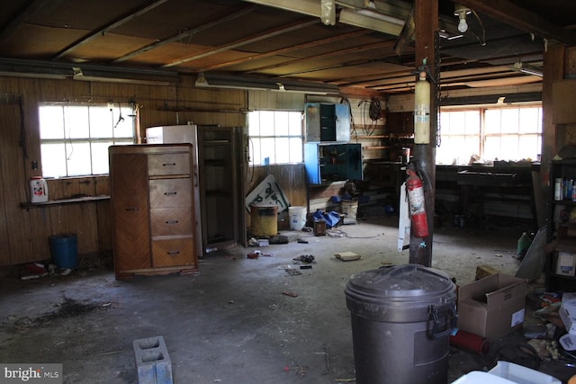 misc room with plenty of natural light and wooden walls