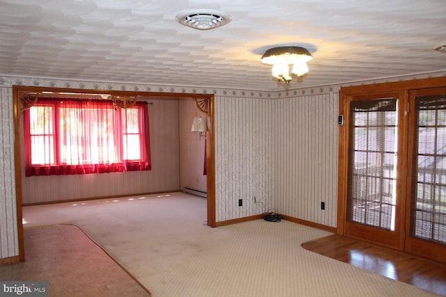 empty room with visible vents, baseboards, and a baseboard radiator