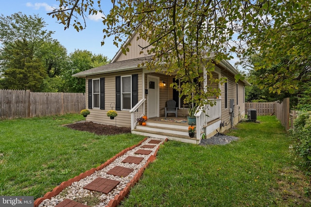 view of front of property with central AC, a front lawn, and covered porch