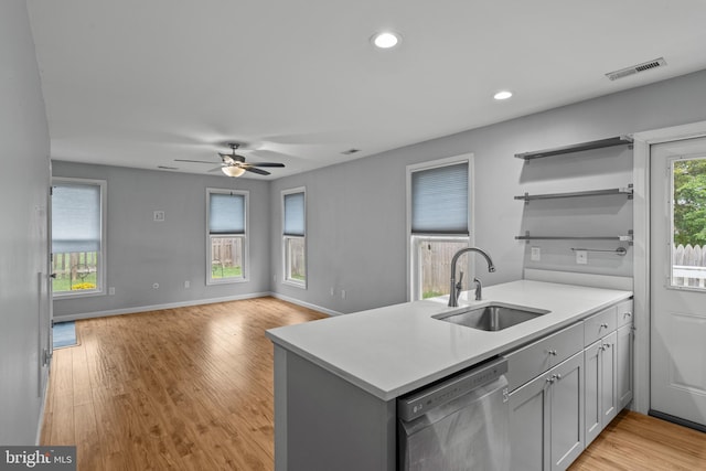 kitchen with ceiling fan, sink, kitchen peninsula, light hardwood / wood-style flooring, and dishwasher