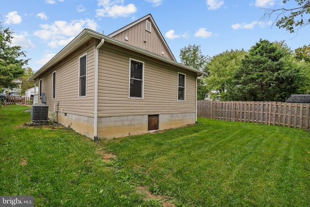 view of property exterior with a lawn and cooling unit