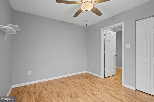 spare room with light wood-type flooring and ceiling fan