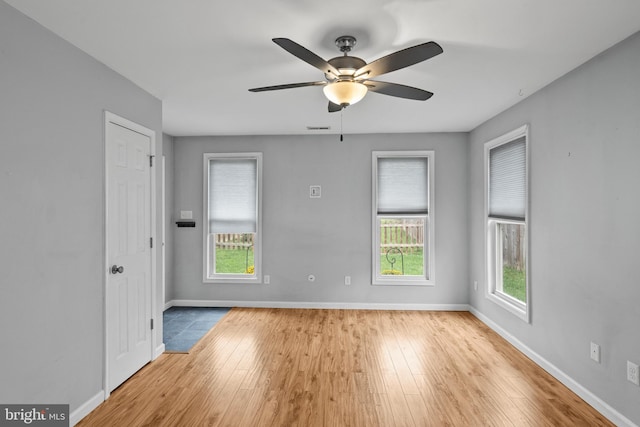 unfurnished room featuring ceiling fan and light wood-type flooring