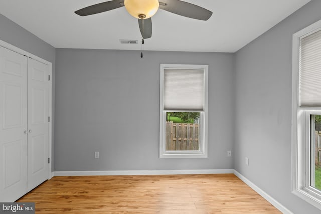 interior space with a closet, light hardwood / wood-style floors, and ceiling fan