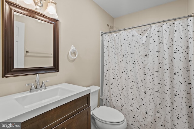 bathroom with vanity, toilet, and a shower with curtain