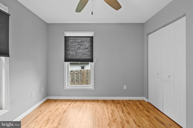 unfurnished bedroom with a closet, light hardwood / wood-style floors, and ceiling fan